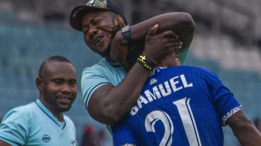 Coach Daniel Yemi hugging Wisdom Samuel after scoring foe Rivers United against Bendel Insurance