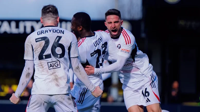 Nigerian forwards Daniel Udoh celebrating his goal for Salford City with teammates