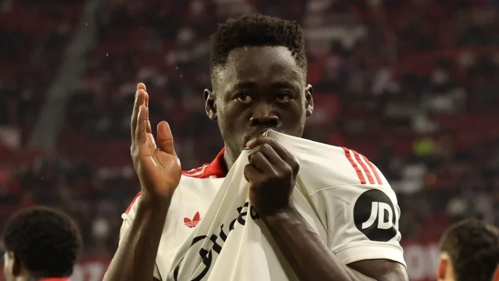 Akor Adams kissing Sevilla badge